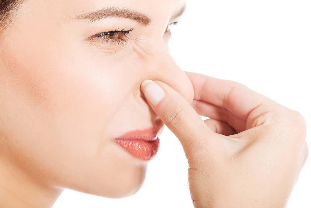 Woman reacting to mold smell musty ,olds smell olor moho
